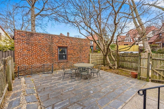 view of patio with outdoor dining space and a fenced backyard