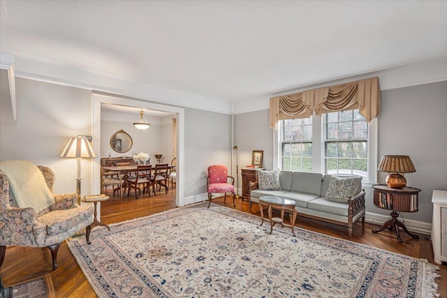 living area featuring baseboards and wood finished floors