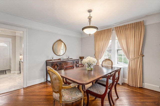 dining room with baseboards and wood finished floors