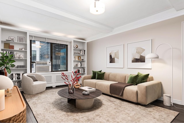 living room with cooling unit, beam ceiling, wood finished floors, and ornamental molding