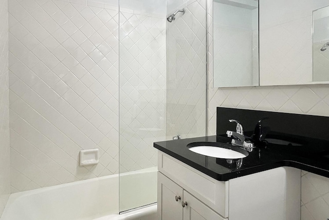 bathroom with vanity, shower / bathing tub combination, and decorative backsplash