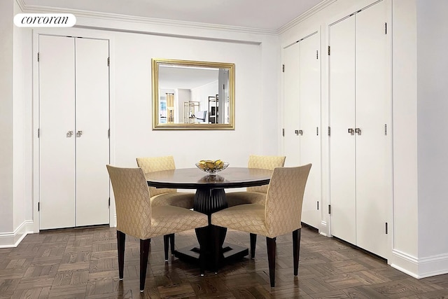 dining room featuring crown molding and baseboards
