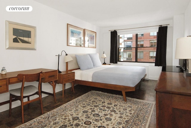 bedroom featuring wood finished floors and visible vents