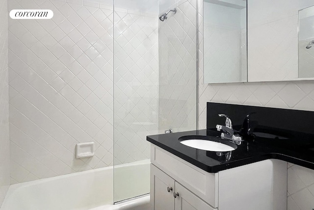 bathroom with tub / shower combination, backsplash, and vanity