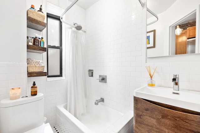 315 E 12th St Unit 22, New York City, NY 10003 - full bathroom featuring tile walls, shower / bathtub combination with curtain, toilet, and vanity