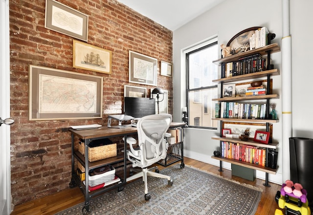 315 E 12th St Unit 22, New York City, NY 10003 - office featuring baseboards, wood finished floors, and brick wall