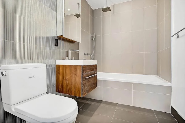 bathroom featuring vanity, tile walls, toilet, and tile patterned floors