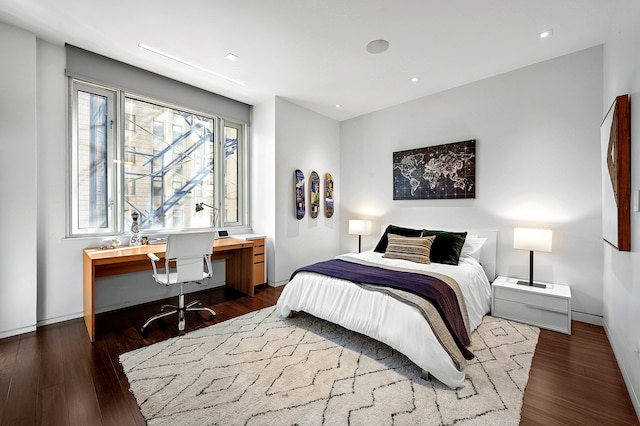 bedroom with recessed lighting, dark wood finished floors, and baseboards