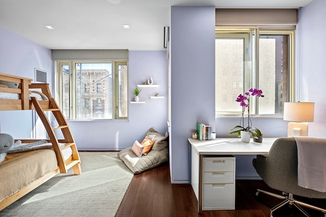 bedroom featuring visible vents, dark wood-type flooring, and multiple windows