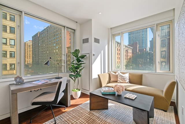 sunroom with a view of city and visible vents