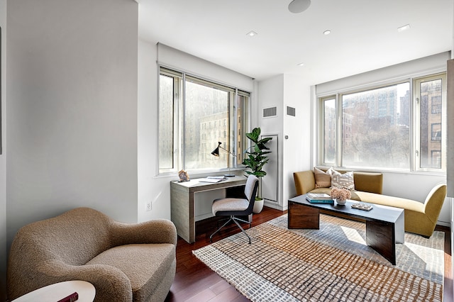 sitting room featuring visible vents and wood finished floors