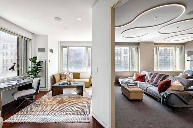 interior space featuring baseboards, wood finished floors, and visible vents