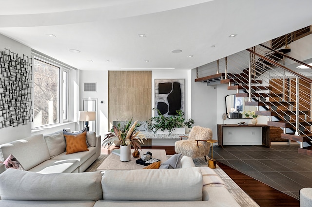 living room with wood finished floors, stairs, visible vents, and recessed lighting