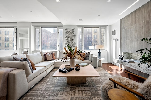 living area with visible vents and wood finished floors