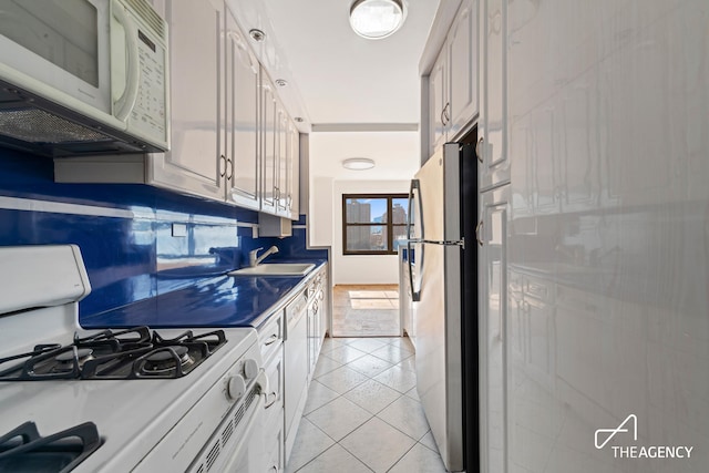 142 W End Ave Unit 6U, New York City, NY 10023 - kitchen with white appliances, a sink, and light tile patterned floors