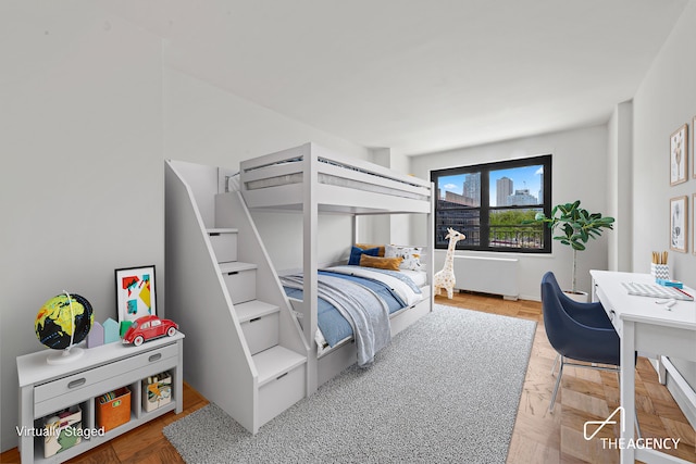 142 W End Ave Unit 6U, New York City, NY 10023 - bedroom featuring radiator, an office area, and baseboards
