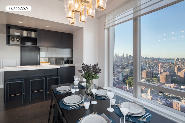 252 S St Unit 10H, New York City, NY 10002 - dining room featuring dark wood-style floors, a view of city, and a chandelier