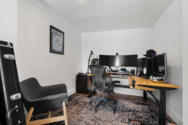 office space featuring baseboards and wood finished floors