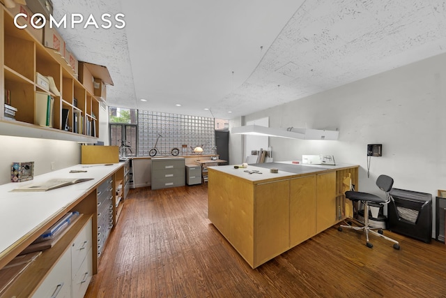 219 E 49th St, New York City, NY 10017 - kitchen featuring light countertops, a peninsula, and dark wood-type flooring
