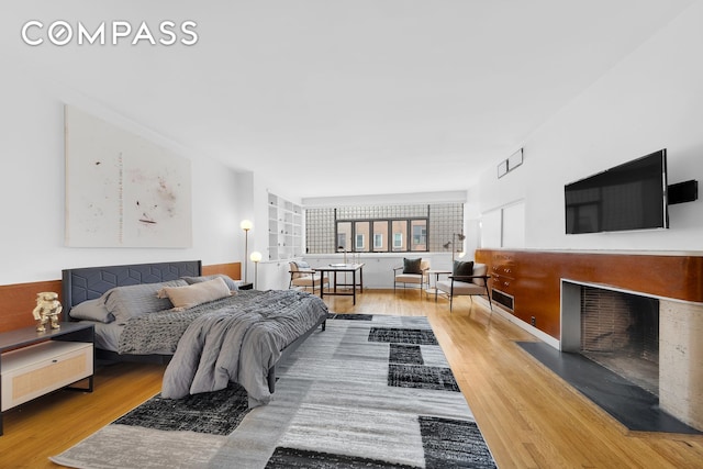 219 E 49th St, New York City, NY 10017 - bedroom with wood finished floors and a fireplace