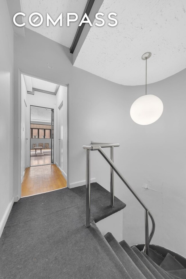 219 E 49th St, New York City, NY 10017 - stairway featuring baseboards and carpet floors