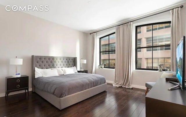 bedroom with dark wood-style floors and baseboards