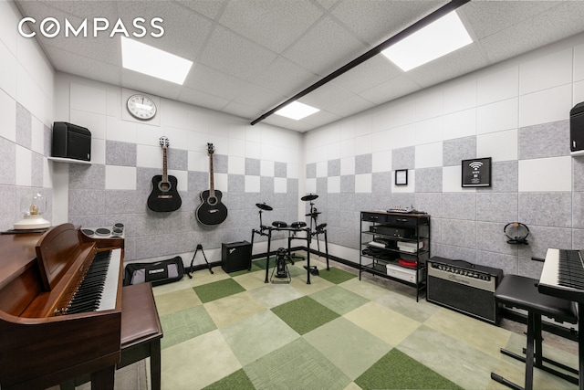 miscellaneous room with a drop ceiling, tile patterned floors, and tile walls