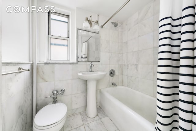 full bathroom featuring shower / bath combo, toilet, and tile walls