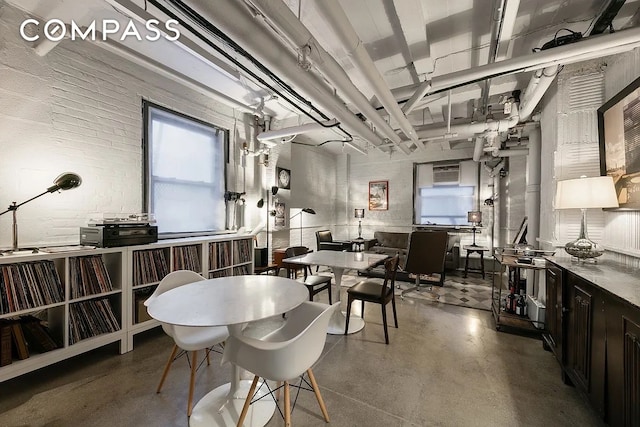 dining space featuring finished concrete flooring