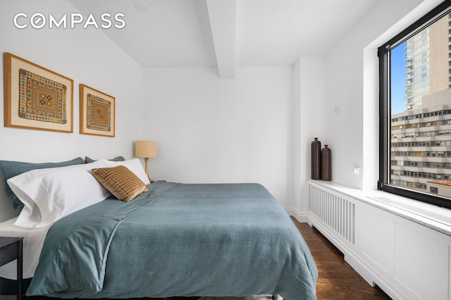 227 E 57th St Unit 18Bf, New York City, NY 10022 - bedroom with dark wood finished floors and beam ceiling