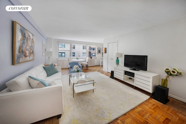 living area featuring baseboards and visible vents
