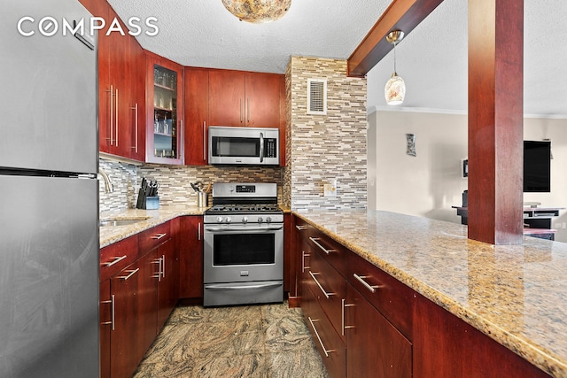 333 Pearl St Unit 6K, New York City, NY 10038 - kitchen with stainless steel appliances, dark brown cabinets, crown molding, backsplash, and a textured ceiling