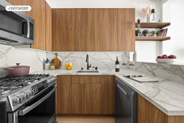 1198 Jefferson Ave Unit B, New York City, NY 11221 - kitchen featuring modern cabinets, light wood-type flooring, brown cabinets, a sink, and stainless steel appliances