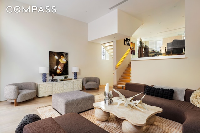 276 Berry St, New York City, NY 11249 - living room featuring stairway and light wood-type flooring
