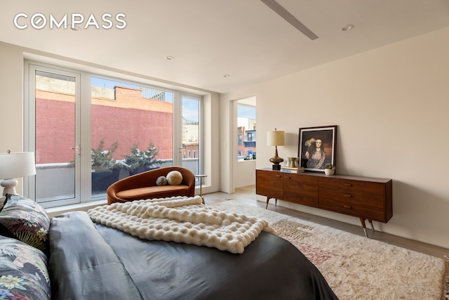 276 Berry St, New York City, NY 11249 - bedroom featuring light wood-style floors and access to outside