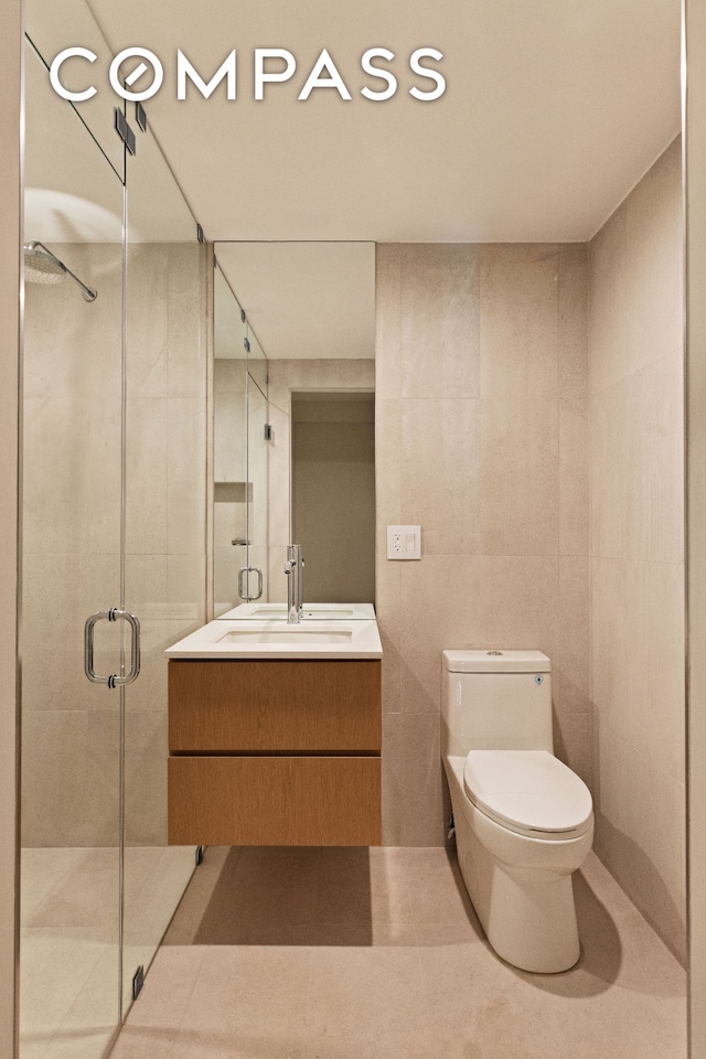 276 Berry St, New York City, NY 11249 - full bath with tile walls, a stall shower, vanity, tile patterned floors, and toilet