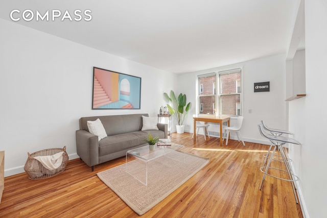 living area with baseboards and light wood-style floors