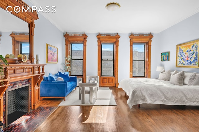 bedroom featuring crown molding and wood-type flooring