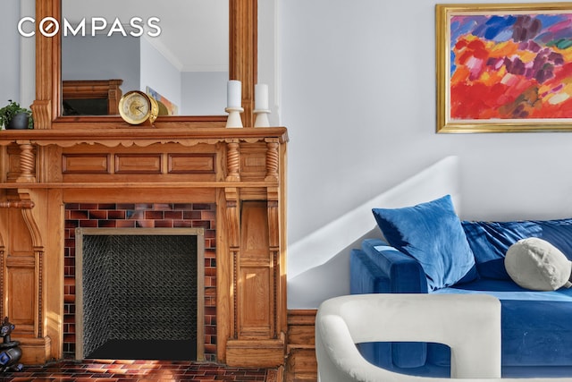 living area featuring brick floor and crown molding