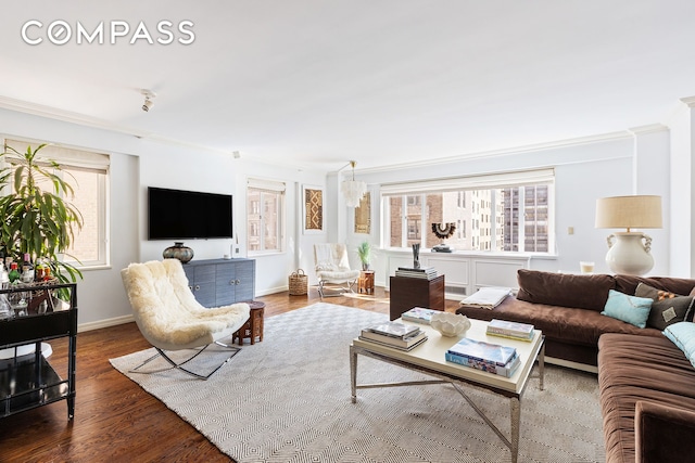 135 E 71st St Unit 9D, New York City, NY 10021 - living room featuring crown molding, baseboards, and wood finished floors