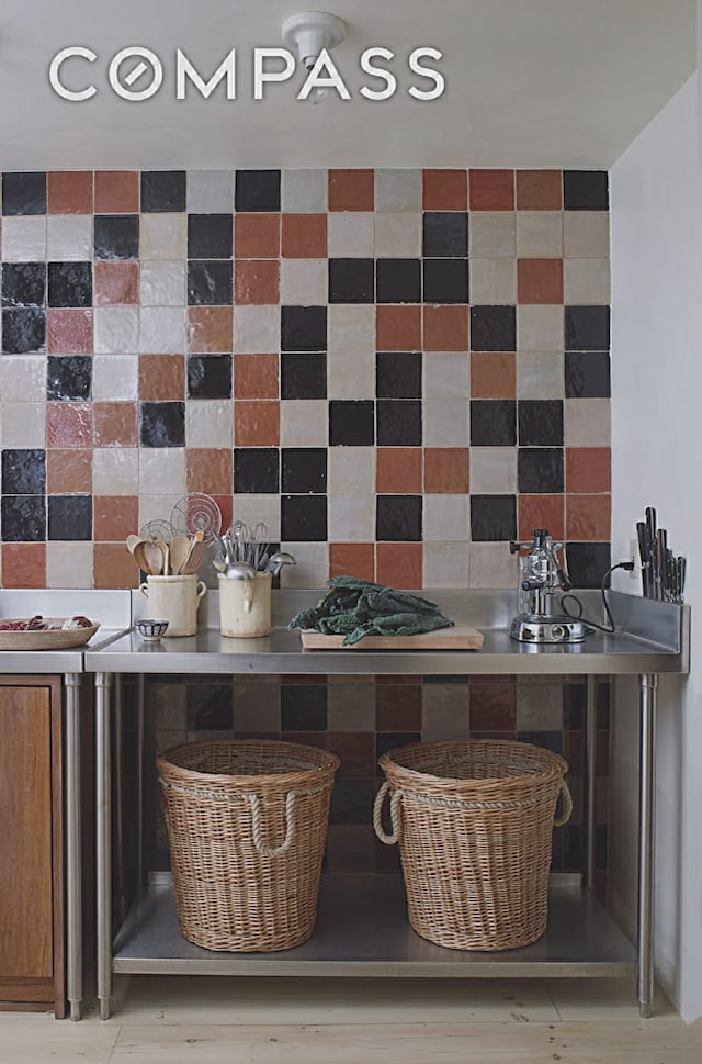 125 W 15th St, New York City, NY 10011 - kitchen featuring backsplash and brown cabinetry