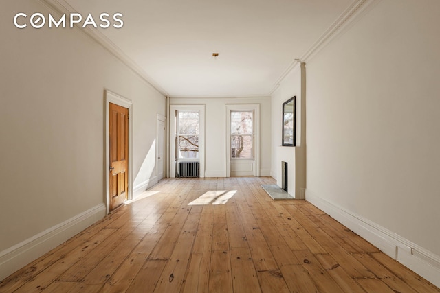 125 W 15th St, New York City, NY 10011 - unfurnished room with crown molding, light wood-style floors, radiator heating unit, and baseboards