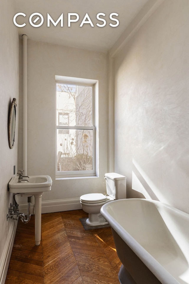 125 W 15th St, New York City, NY 10011 - bathroom with toilet, baseboards, and a freestanding bath