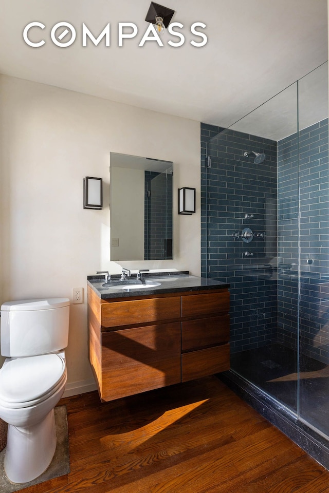 125 W 15th St, New York City, NY 10011 - bathroom featuring wood finished floors, vanity, and a stall shower