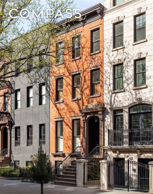 125 W 15th St, New York City, NY 10011 - view of building exterior with a fenced front yard