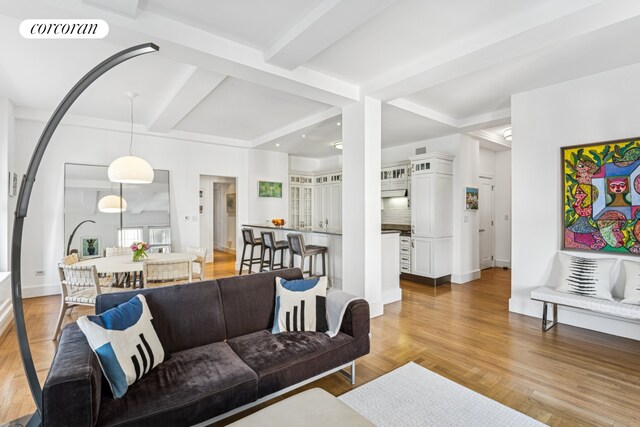 27 W 72nd St Unit 1615, New York City, NY 10023 - living area featuring beamed ceiling, light wood finished floors, and baseboards