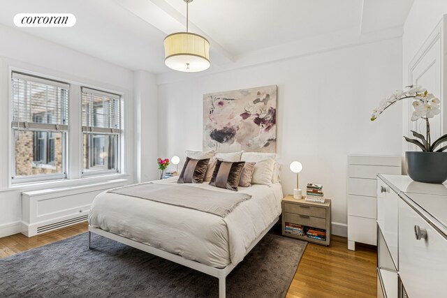 27 W 72nd St Unit 1615, New York City, NY 10023 - bedroom with light wood-type flooring, baseboards, and beam ceiling
