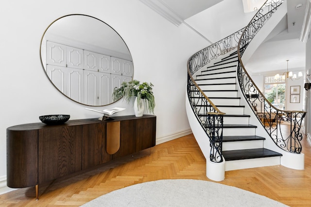staircase featuring a notable chandelier and ornamental molding