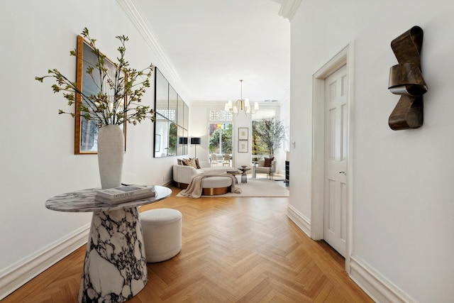 hall featuring crown molding, baseboards, and a chandelier