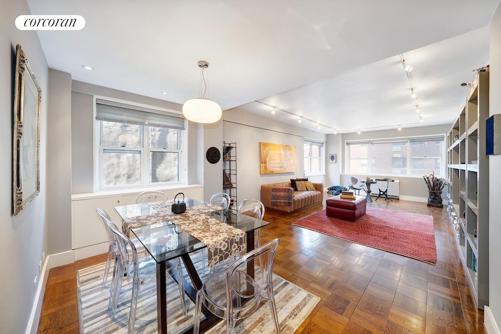 dining space with baseboards, rail lighting, visible vents, and recessed lighting